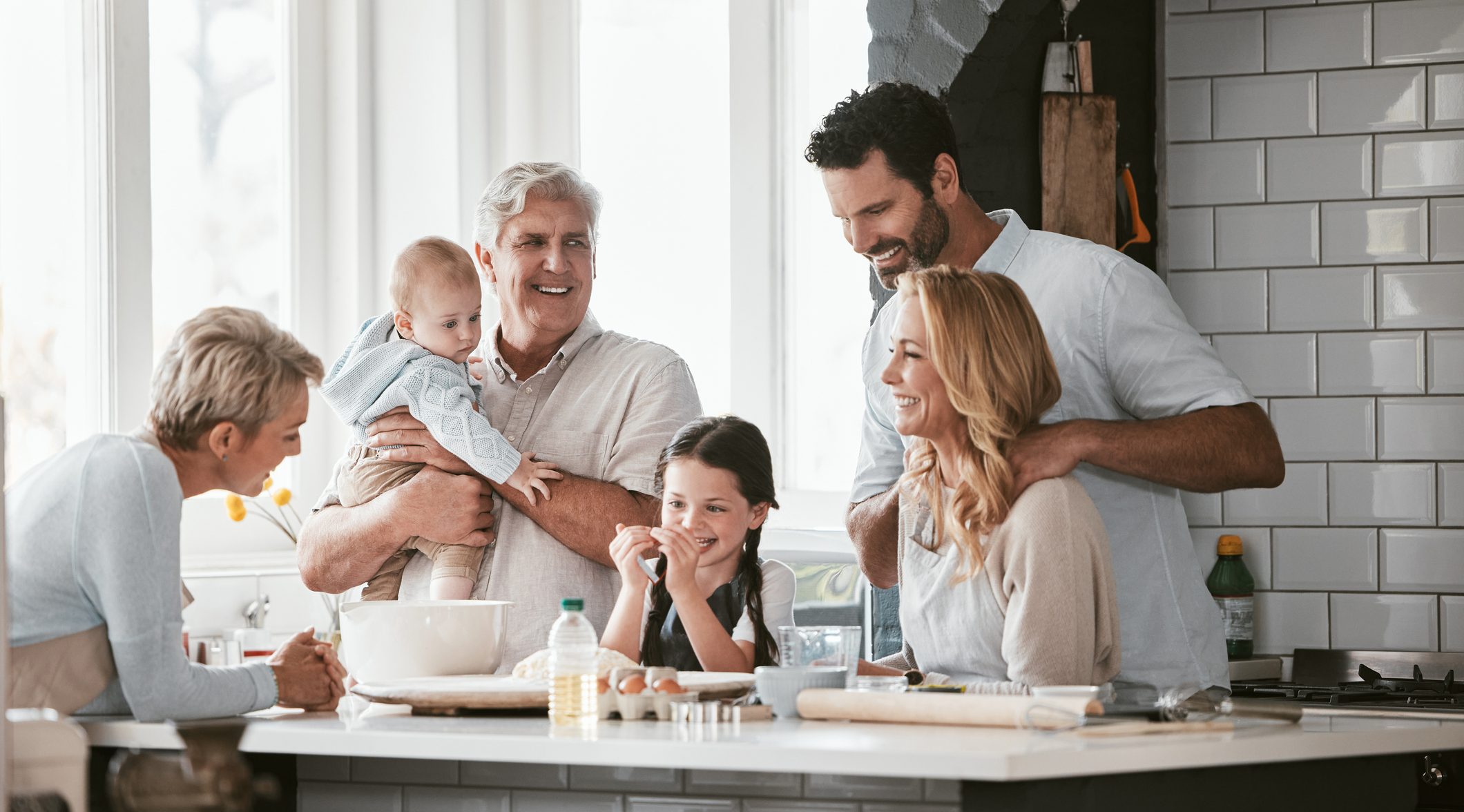 Multi-Generational family, love and cooking in home kitchen, bonding or having fun. Support, care and grandparents, father and mother, baby and girl baking, learning and talking while enjoying quality time together